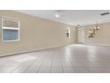 Spacious living area with neutral paint, tile floors, and abundant natural light at 15121 Searobbin Dr, Lakewood Ranch, FL 34202