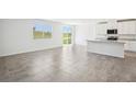 Open-concept living area with tile floors and plenty of natural light from the windows at 31610 Malbec Dr, Brooksville, FL 34602