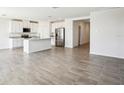 Spacious open-concept layout with a large kitchen island and modern stainless steel appliances at 31668 Wild Grape Ln, Brooksville, FL 34602