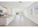 Open-concept living space with tile flooring and ample natural light at 3553 Moscato Dr, Brooksville, FL 34602