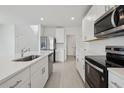 Kitchen featuring white cabinets, stainless steel appliances, and large island at 3634 Moscato Dr, Brooksville, FL 34602