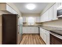 Modern kitchen with stainless steel appliances, granite countertops, and white cabinets, perfect for cooking at 777 27Th S Ave, St Petersburg, FL 33705