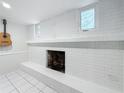 Fireplace painted white, creating a calming space; a guitar hangs nearby on the wall at 8135 33Rd Ave N, St Petersburg, FL 33710