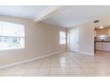 Bright living room with tile flooring, large windows and access to kitchen at 10151 114Th N Ter, Largo, FL 33773