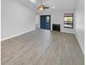 Bright living room showcasing tile floors, a ceiling fan, fireplace, and sliding glass doors for ample natural light at 110 Lakeside Colony Dr, Tarpon Springs, FL 34689