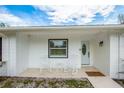 Cozy front porch with rocking chairs and a charming front door at 18526 Sweetbay Ln, Dade City, FL 33523