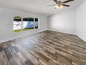 Bright, empty bedroom with new flooring, a ceiling fan, and plenty of natural light from the windows at 2052 Sheffield Ct, Oldsmar, FL 34677