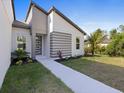 Stunning single-Gathering home with modern architecture, landscaped garden, and a welcoming walkway at 24520 Kingsway Cir, Punta Gorda, FL 33983