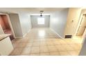 Spacious living room with neutral paint, tile flooring, a ceiling fan, and natural light from a window at 552 Golden Raintree Pl, Brandon, FL 33510