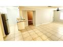 Open-concept living space featuring tile flooring, neutral paint, and a kitchen area with updated countertops at 552 Golden Raintree Pl, Brandon, FL 33510