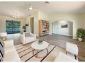 Bright living room featuring modern furnishings, new flooring, and a view of the pool at 18284 Yale Ave, Port Charlotte, FL 33948