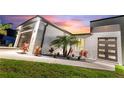 Eye-catching contemporary home boasting a dark front door and meticulous rock and plant landscaping at 24470 Kingsway Cir, Punta Gorda, FL 33983