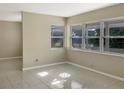 Open living room with tile floors and ample natural light from large windows at 301 Francis Dr, Apollo Beach, FL 33572