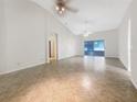 Spacious open-concept living room with vaulted ceilings and sliding glass doors for ample natural light at 1110 Mcdaniel St # 1110, Sun City Center, FL 33573