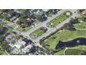 Aerial view of property near landscaped traffic circles, golf course, and lake with fountain at 515 Snell Isle Ne Blvd, St Petersburg, FL 33704