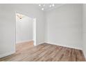 Bright living room with wood floors and an open doorway at 5516 Madrigal Way, Apollo Beach, FL 33572