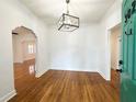 Bright dining room featuring gleaming hardwood floors and a modern chandelier at 3025 W North A St, Tampa, FL 33609
