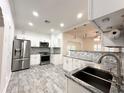 Modern kitchen boasts stainless steel appliances and granite countertops at 3025 W North A St, Tampa, FL 33609