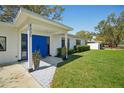 Inviting front entrance showcasing patterned tiles and a vibrant blue double door at 4335 S Coolidge Ave, Tampa, FL 33611