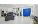 Open concept living room with modern decor and striking blue double doors at 4335 S Coolidge Ave, Tampa, FL 33611