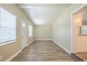 Bright living room featuring wood-look floors and fresh, neutral paint at 3720 E Idlewild Ave, Tampa, FL 33610
