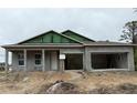 Unfinished single-story home with two-car garage and covered entry in a construction zone at 2994 Alesio Ave, North Port, FL 34286