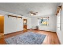 Bright living room featuring hardwood floors, natural light, and a ceiling fan for added comfort at 8608 N 20Th St, Tampa, FL 33604