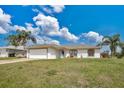 Attractive single-story home boasting a two-car garage, landscaped yard, and palm trees at 7280 Meroni Blvd, North Port, FL 34291