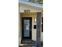 Close-up of the front door with contemporary design and address plaque at 1825 Alberta Dr, Clearwater, FL 33756