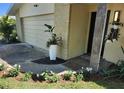Beautiful landscaping and flowerbeds accent the front entrance with a lovely curb appeal at 1825 Alberta Dr, Clearwater, FL 33756