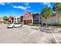 Attractive condo complex with vibrant exterior, lush landscaping, visitor parking, and clear blue skies at 5729 Baywater Dr # 5729, Tampa, FL 33615