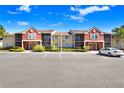 Condo complex featuring a colorful exterior design, screened-in balconies, and well-kept grounds at 5729 Baywater Dr # 5729, Tampa, FL 33615