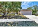 Inviting single-story home featuring a well-maintained lawn and a convenient two-car garage at 669 Lakemont Dr, Brandon, FL 33510