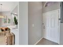 Bright foyer featuring tiled flooring and a view of the dining area at 669 Lakemont Dr, Brandon, FL 33510