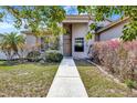 The home's front exterior boasts meticulously landscaped bushes and a welcoming walkway at 669 Lakemont Dr, Brandon, FL 33510
