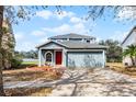 Inviting two-story home featuring a manicured front yard, two-car garage, and lovely curb appeal at 11144 Summer Star Dr, Riverview, FL 33579