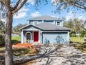 Beautiful two-story home showcasing a well-maintained front yard and classic architectural details at 11144 Summer Star Dr, Riverview, FL 33579
