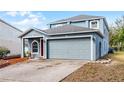 Attractive two-story home with a spacious two-car garage, red front door, and lovely landscaping at 11144 Summer Star Dr, Riverview, FL 33579