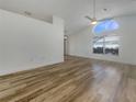 Open floor plan living area featuring hardwood flooring and plenty of natural light at 3527 65Th Avenue E Cir, Sarasota, FL 34243