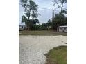 Spacious backyard with lush greenery, mature trees, and a small storage shed at 15168 Chamberlain Blvd, Port Charlotte, FL 33953