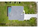 Aerial view showcases a well-maintained home with a screened-in pool, complemented by lush green landscaping at 291 Rotonda S Blvd, Rotonda West, FL 33947