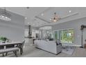 Open concept living room and kitchen area with modern decor and luxury vinyl plank flooring at 291 Rotonda S Blvd, Rotonda West, FL 33947