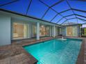 Screened-in pool with brick pavers, an in-pool fountain, and direct access to the home's interior at 291 Rotonda S Blvd, Rotonda West, FL 33947