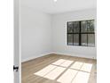 A light filled bedroom with a large window and wood floors creates a bright and inviting atmosphere at 4313 Appleton Ter, North Port, FL 34286
