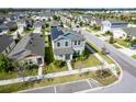 Beautiful aerial view of a two-story home with solar panels in a Gathering-friendly neighborhood at 13001 Pennybrook Dr, Riverview, FL 33579