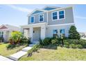 Inviting two-story home features a well-manicured lawn and lush landscaping, creating a picturesque setting at 13001 Pennybrook Dr, Riverview, FL 33579