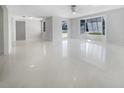 Bright living room boasting sleek flooring, recessed lighting, and a large window at 1540 David Pl, Englewood, FL 34223