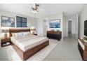 Serene main bedroom with a modern design, a mounted television, and ample closet space at 1540 David Pl, Englewood, FL 34223