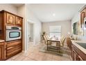 Cozy dining area with wood cabinets, a dining table set for four, and a view to the laundry room at 19012 Quarry Badger Rd, Land O Lakes, FL 34638