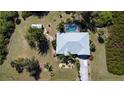 Aerial view of a well maintained property with swimming pool, shed, and mature landscaping at 5769 E Price Blvd, North Port, FL 34288